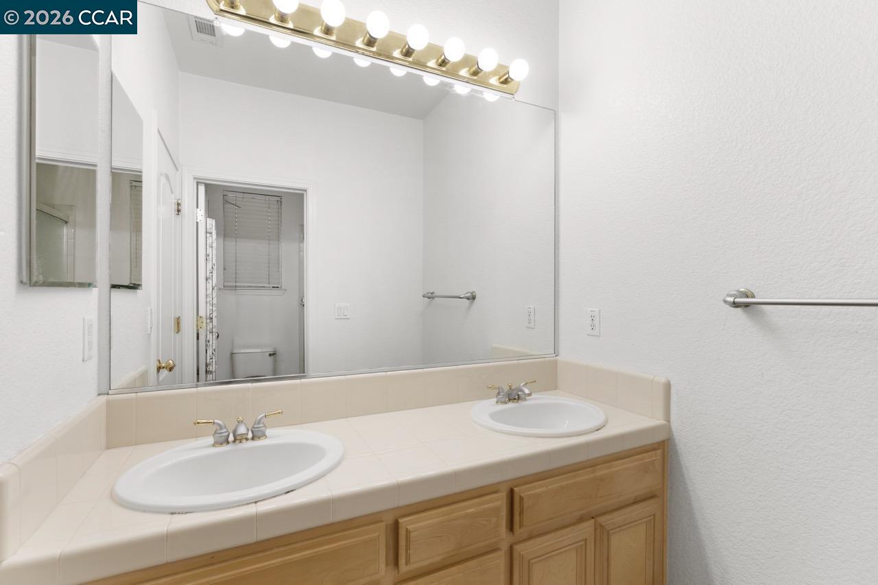 995 Rosehedge Court Concord, CA 94521 - Photo 49 of 70 a bathroom with a sink and a mirror