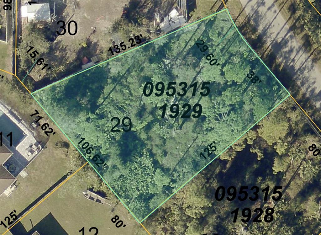 an aerial view of a residential houses with yard