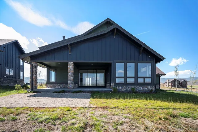 a view of a house with swimming pool next to a yard