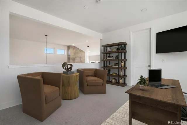 a living room with furniture a flat screen tv and a bookshelf