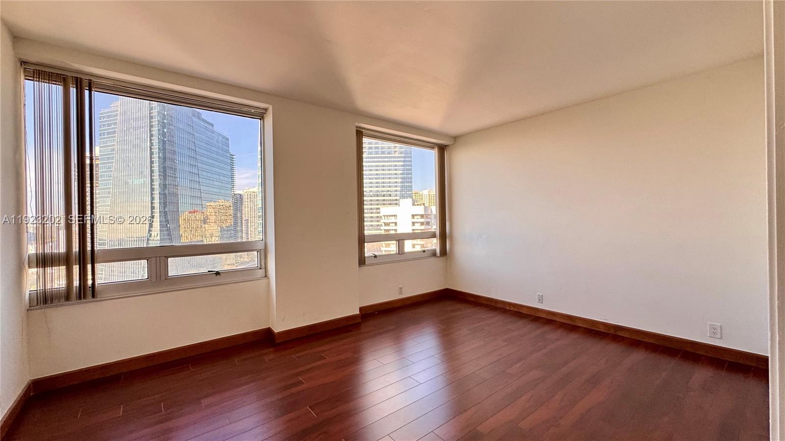 1541 Brickell Avenue, Unit C2705 Miami, FL 33129 - Photo 11 of 13 a view of an empty room with wooden floor and a window