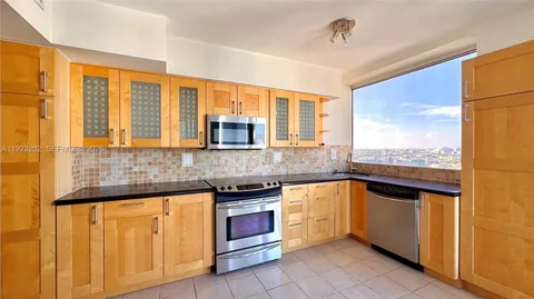 a kitchen with stainless steel appliances granite countertop a stove and a sink