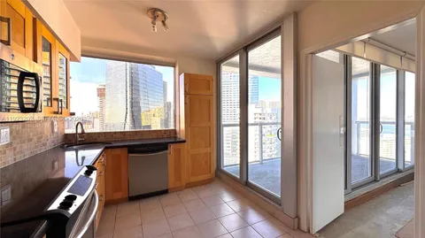 a room with large windows and furniture