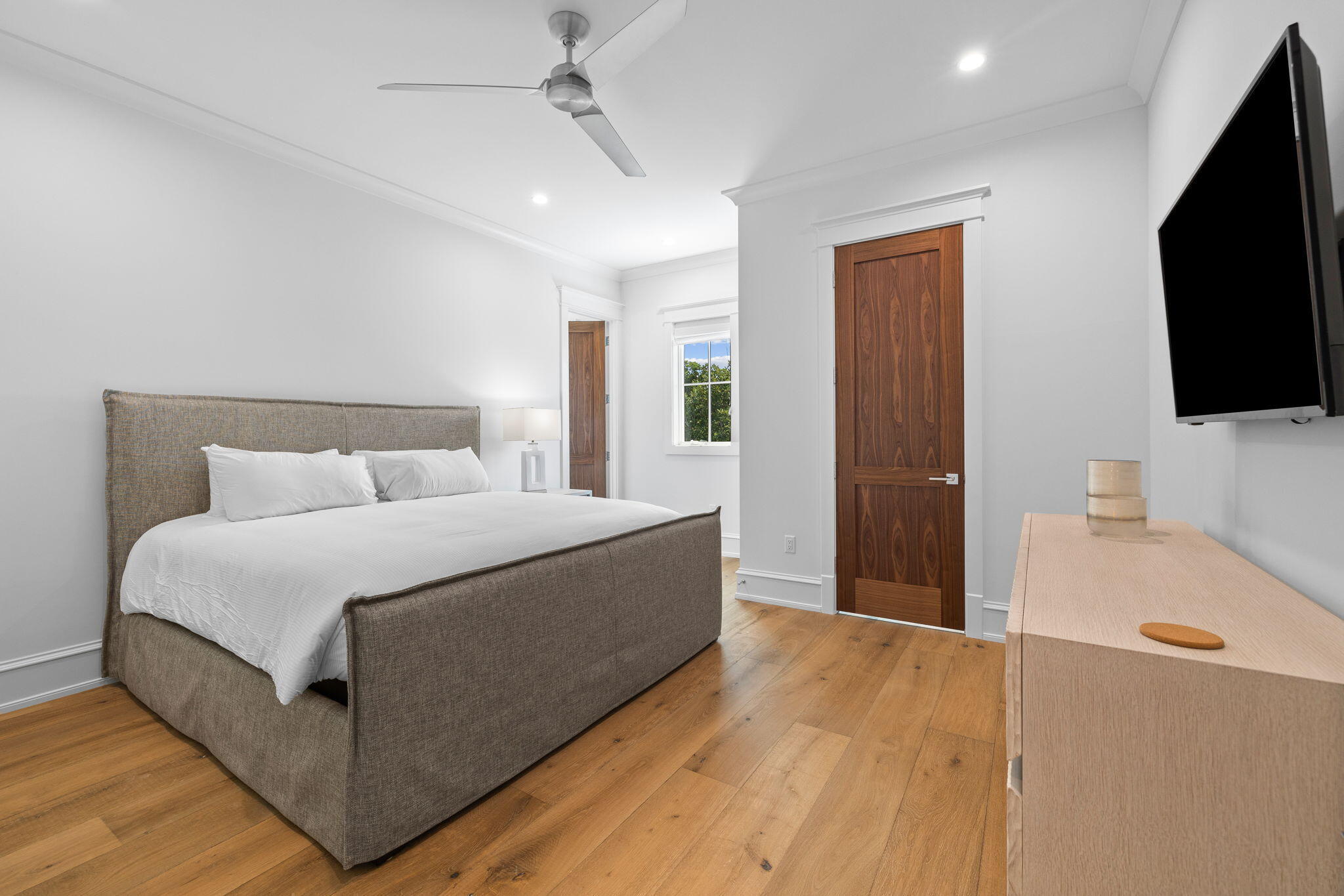 57 Azalea Street Santa Rosa Beach, FL 32459 - Photo 54 of 66 a spacious bedroom with a bed and a flat screen tv