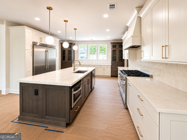 106 Equestrian Drive Forsyth, GA 31029 - Photo 2 of 52 a kitchen with stainless steel appliances granite countertop a sink a stove and a refrigerator