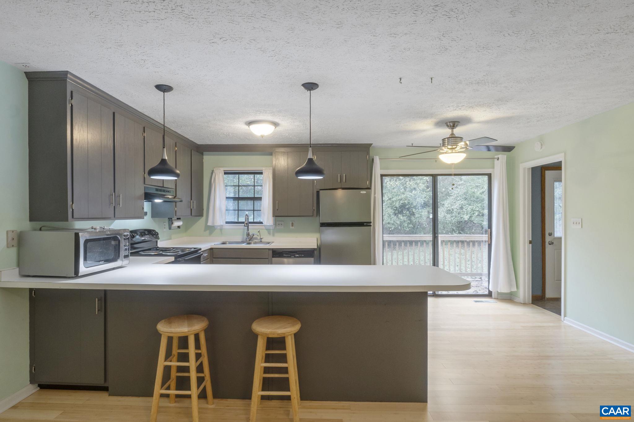 323 Jefferson Drive Palmyra, VA 22963 - Photo 11 of 27 a kitchen with kitchen island granite countertop a sink and refrigerator