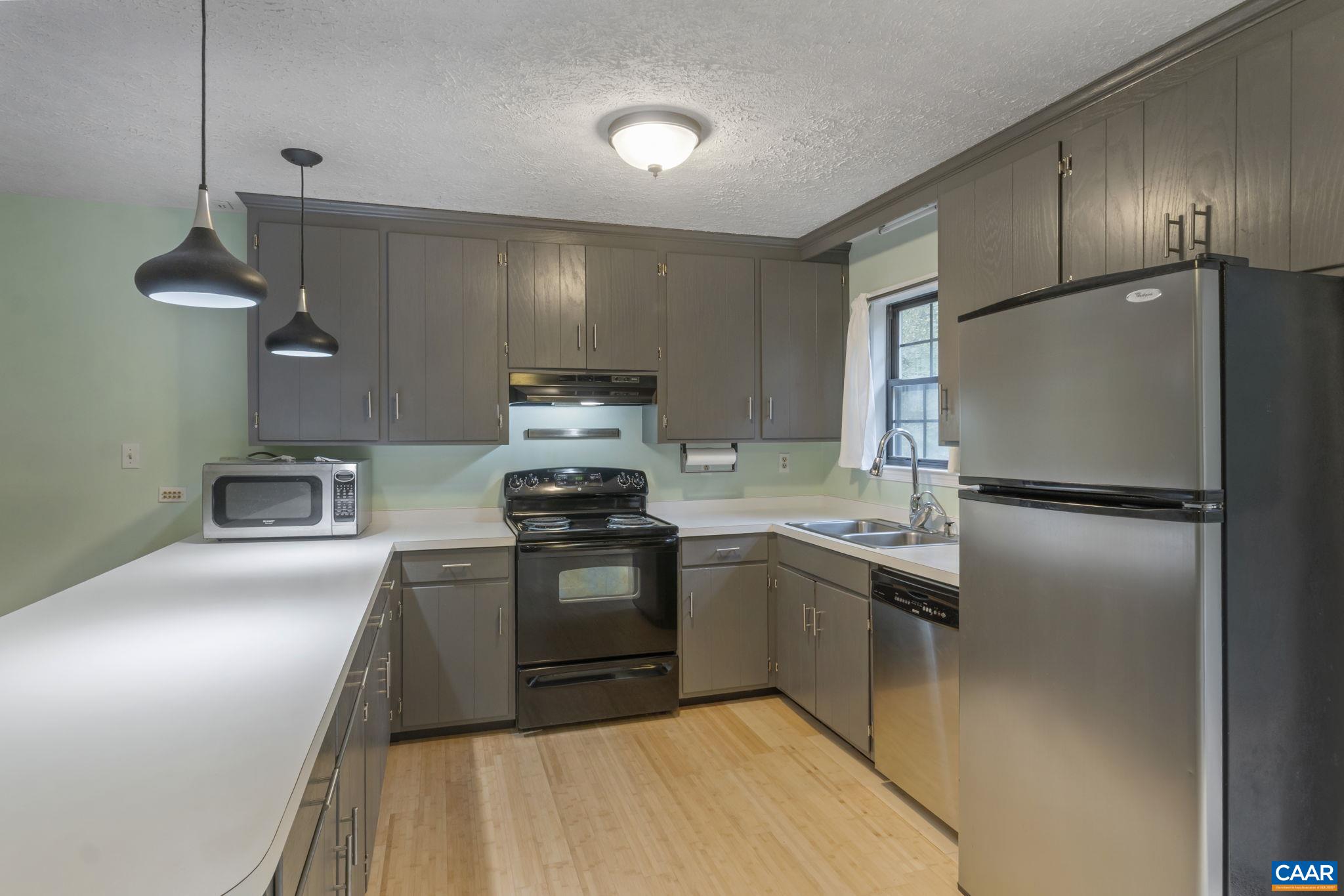 323 Jefferson Drive Palmyra, VA 22963 - Photo 12 of 27 a kitchen with kitchen island granite countertop a sink stainless steel appliances and cabinets