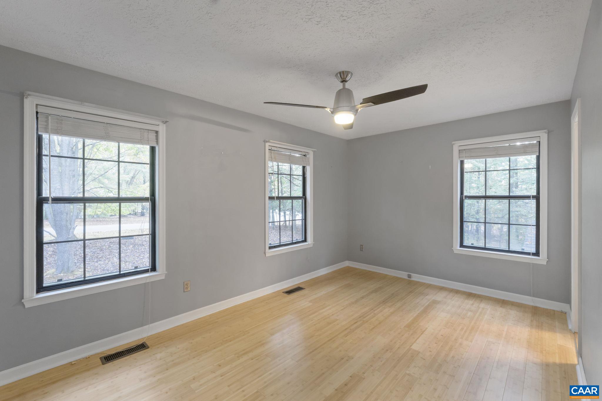 323 Jefferson Drive Palmyra, VA 22963 - Photo 15 of 27 a view of an empty room with a window and wooden floor