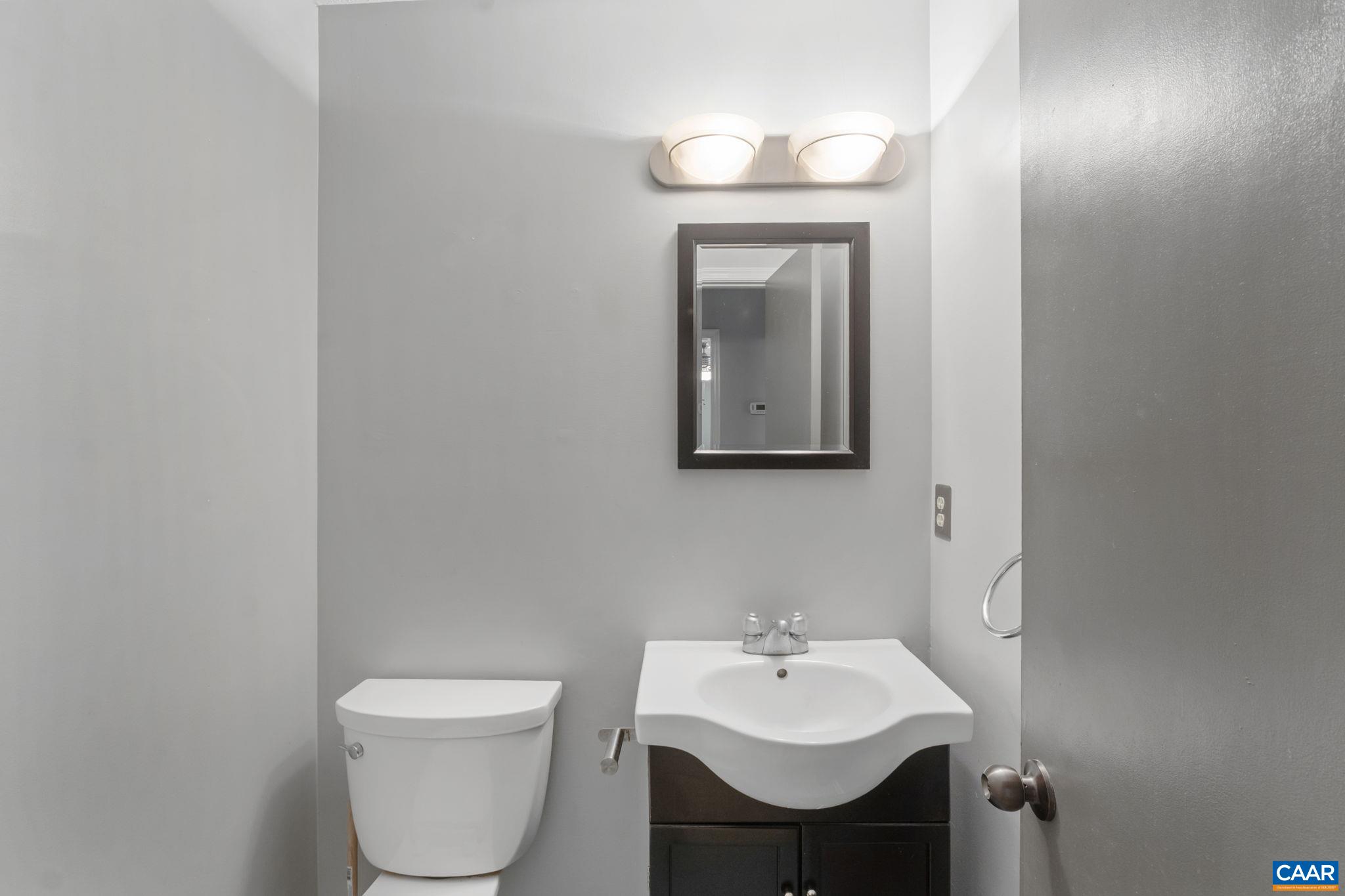 323 Jefferson Drive Palmyra, VA 22963 - Photo 17 of 27 a bathroom with a toilet a sink and mirror