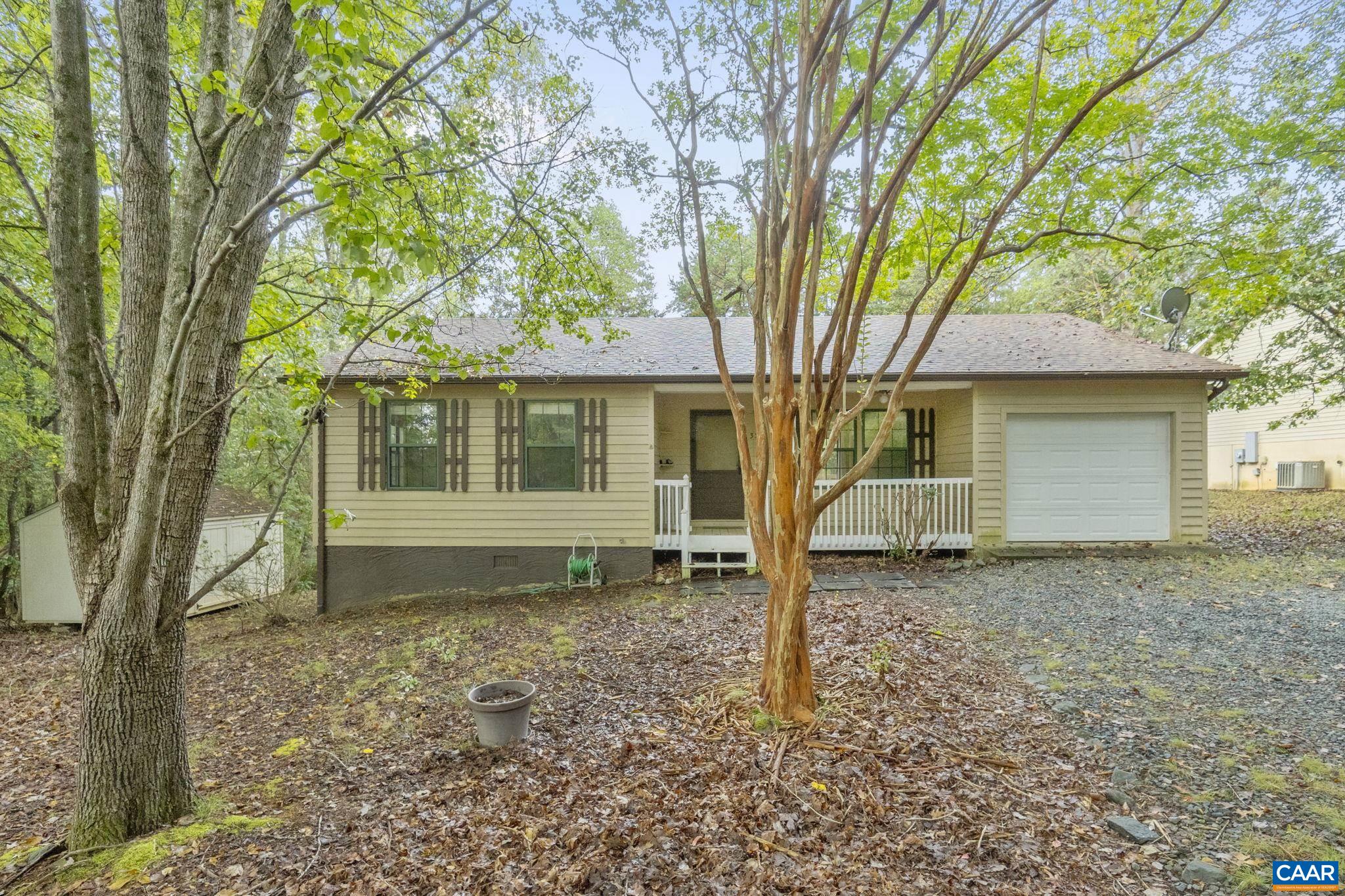 323 Jefferson Drive Palmyra, VA 22963 - Photo 3 of 27 a house with trees in the background