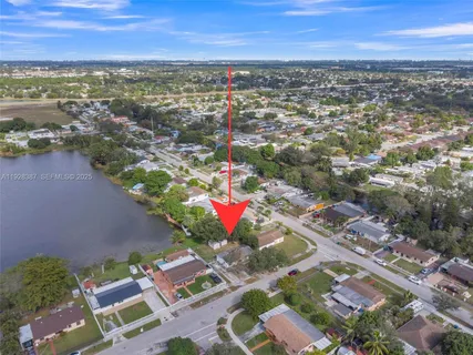 an aerial view of residential building with outdoor space and ocean view