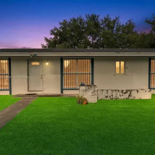 a garden with trees in the background