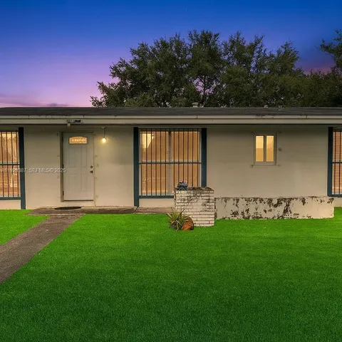 a garden with trees in the background