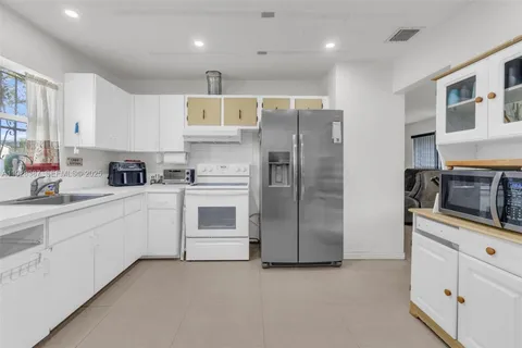 a kitchen with cabinets stainless steel appliances and a counter space