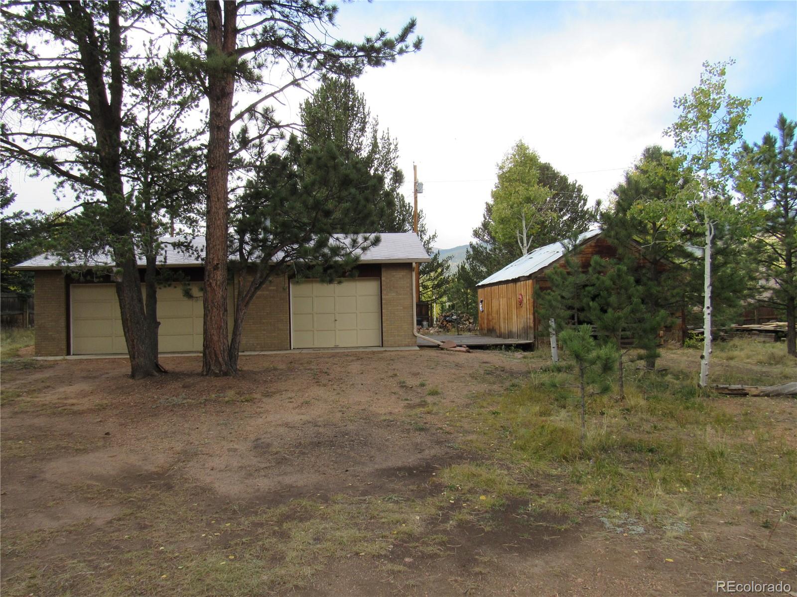 211 Sullivan Street Bailey, CO 80421 - Photo 1 of 15 a house with trees in the background