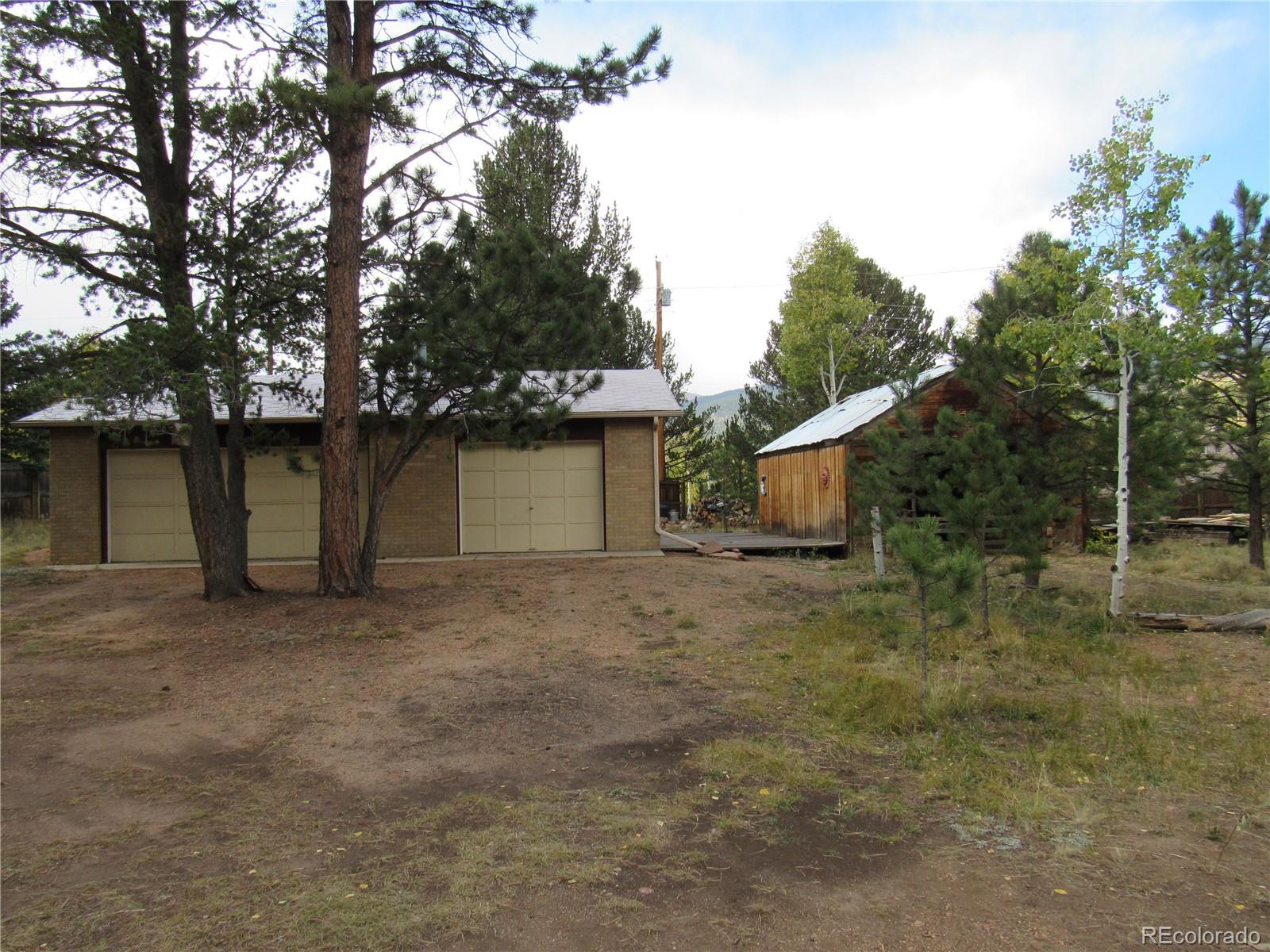 211 Sullivan Street Bailey, CO 80421 - Photo 11 of 15 a house with trees in the background