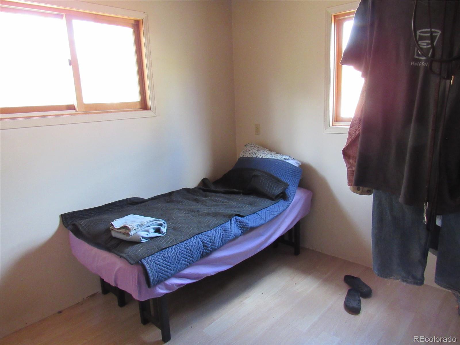 211 Sullivan Street Bailey, CO 80421 - Photo 5 of 15 a bed sitting in a bedroom next to a window