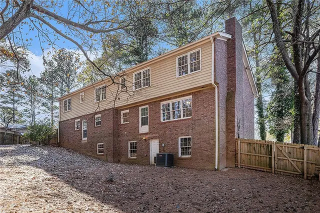 a view of a brick house next to a yard