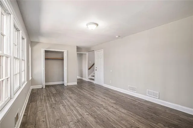 wooden floor in an empty room with a window