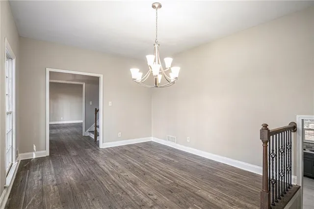 a view of a room with wooden floor fan and window