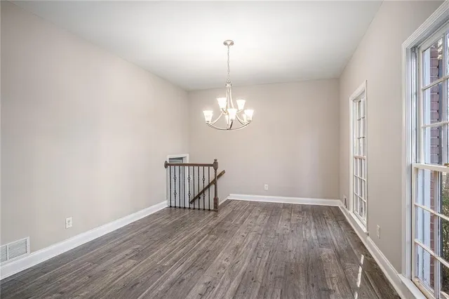 a view of a room with wooden floor and window