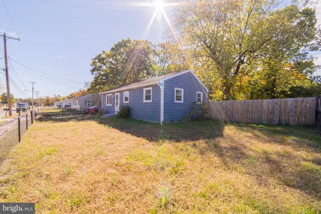a view of a house with wooden fence