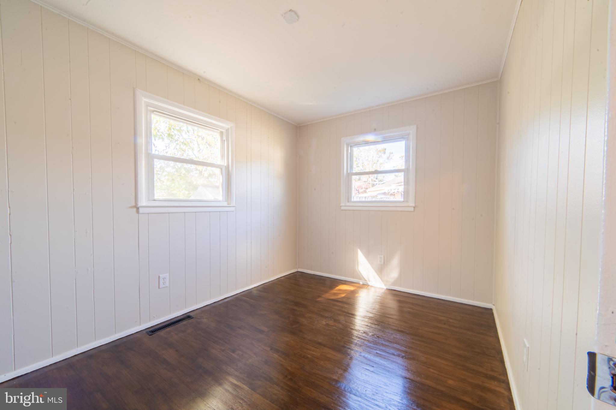 519 Berkeley Drive Browns Mills, NJ 08015 - Photo 18 of 25 an empty room with wooden floor and windows