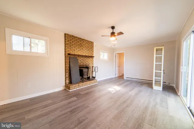 wooden floor in an empty room with a window