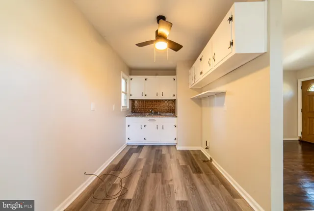 a view of hallway with wooden floor
