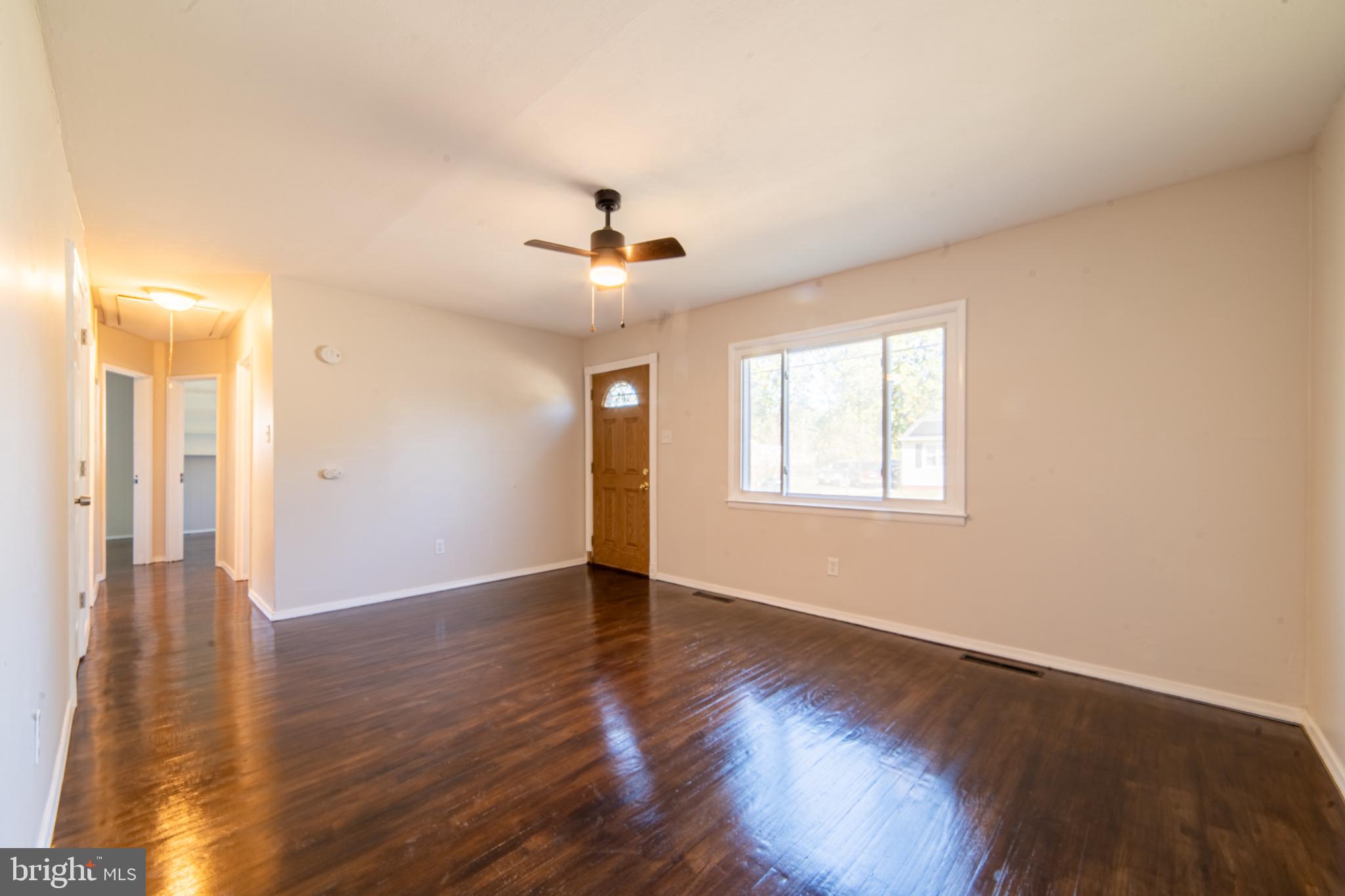 519 Berkeley Drive Browns Mills, NJ 08015 - Photo 5 of 25 a view of an empty room with wooden floor and a window