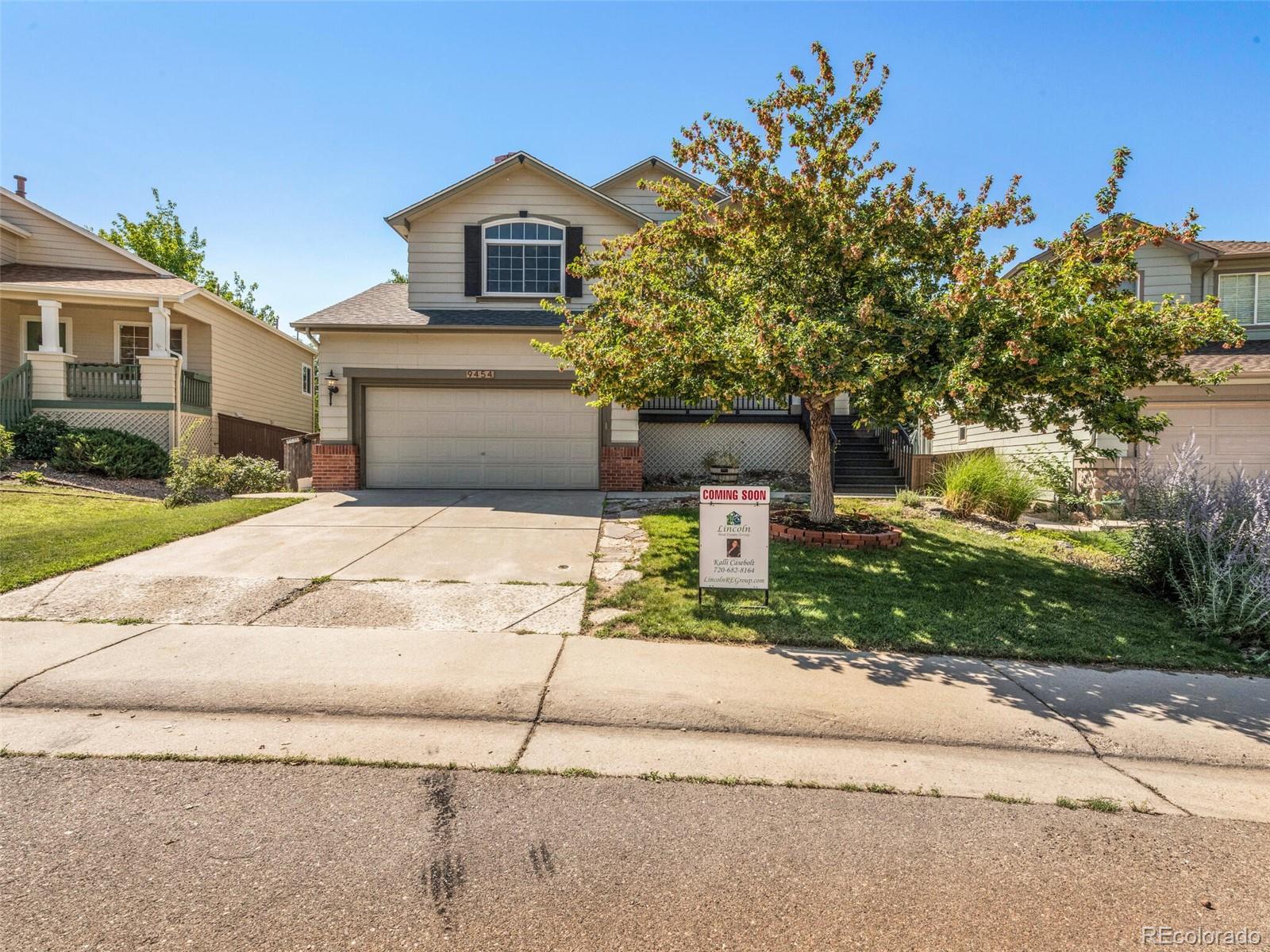 9454 Wolfe Place Highlands Ranch, CO 80129 - Photo 12 of 31 a front view of a house with a yard
