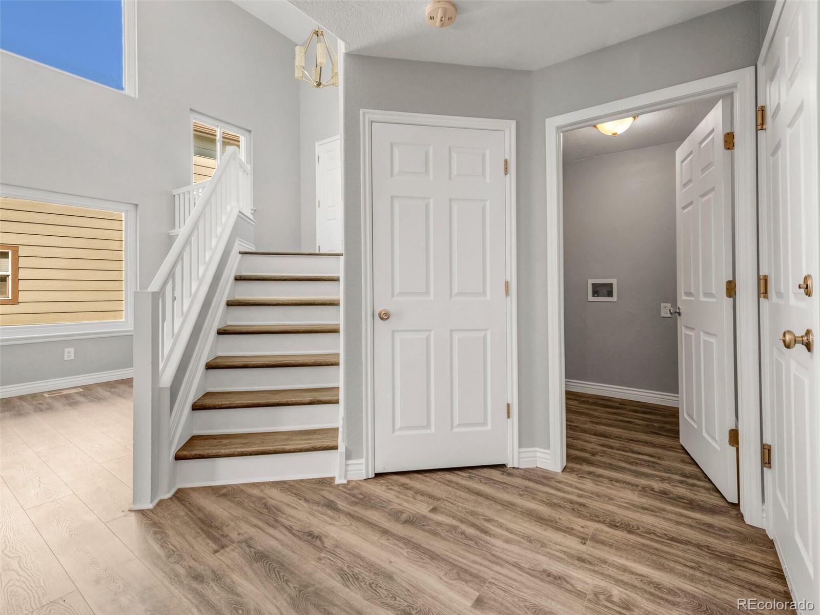 9454 Wolfe Place Highlands Ranch, CO 80129 - Photo 13 of 31 a view of a hallway with wooden floor and entryway
