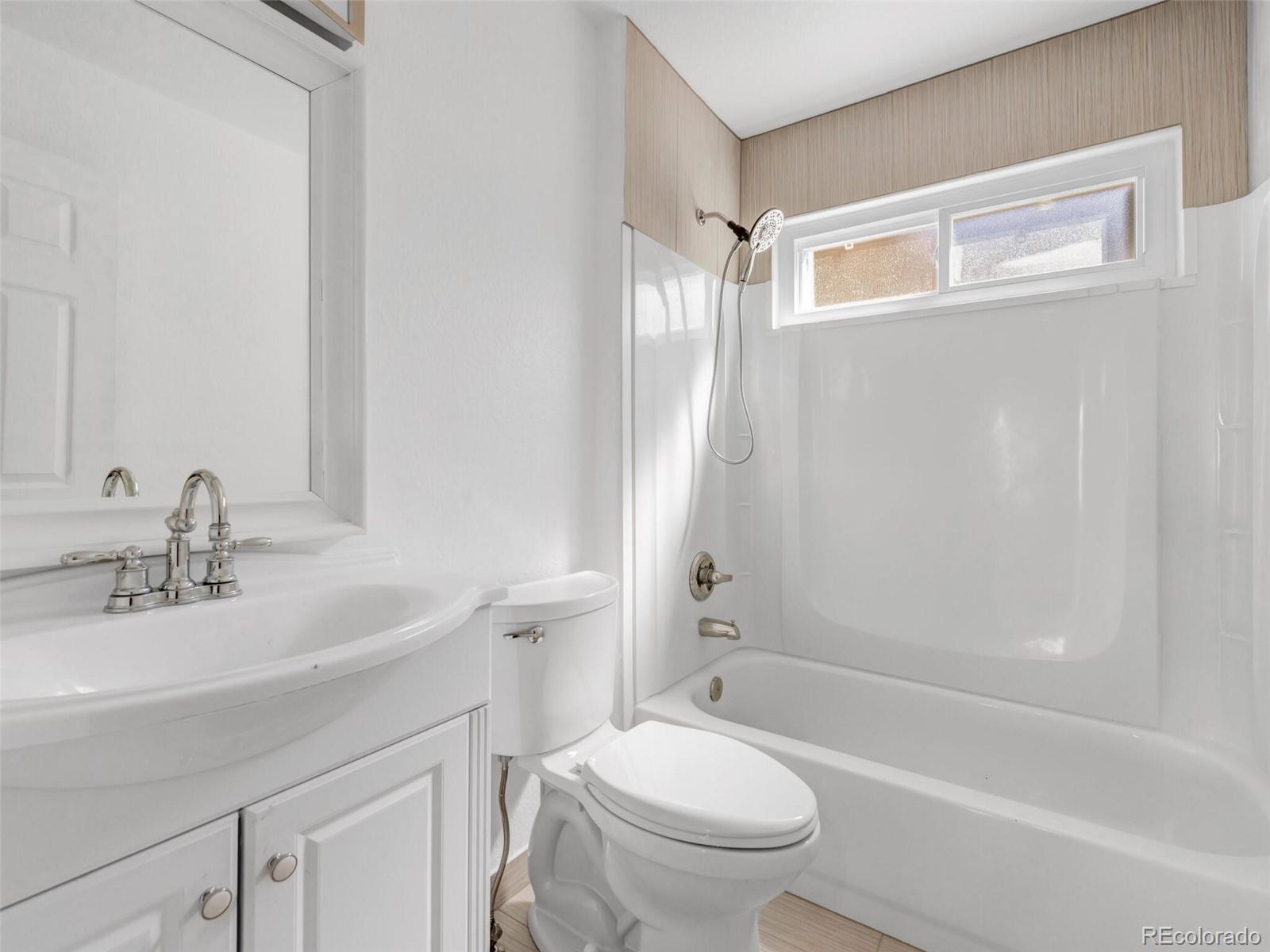 9454 Wolfe Place Highlands Ranch, CO 80129 - Photo 14 of 31 a bathroom with a sink toilet and shower