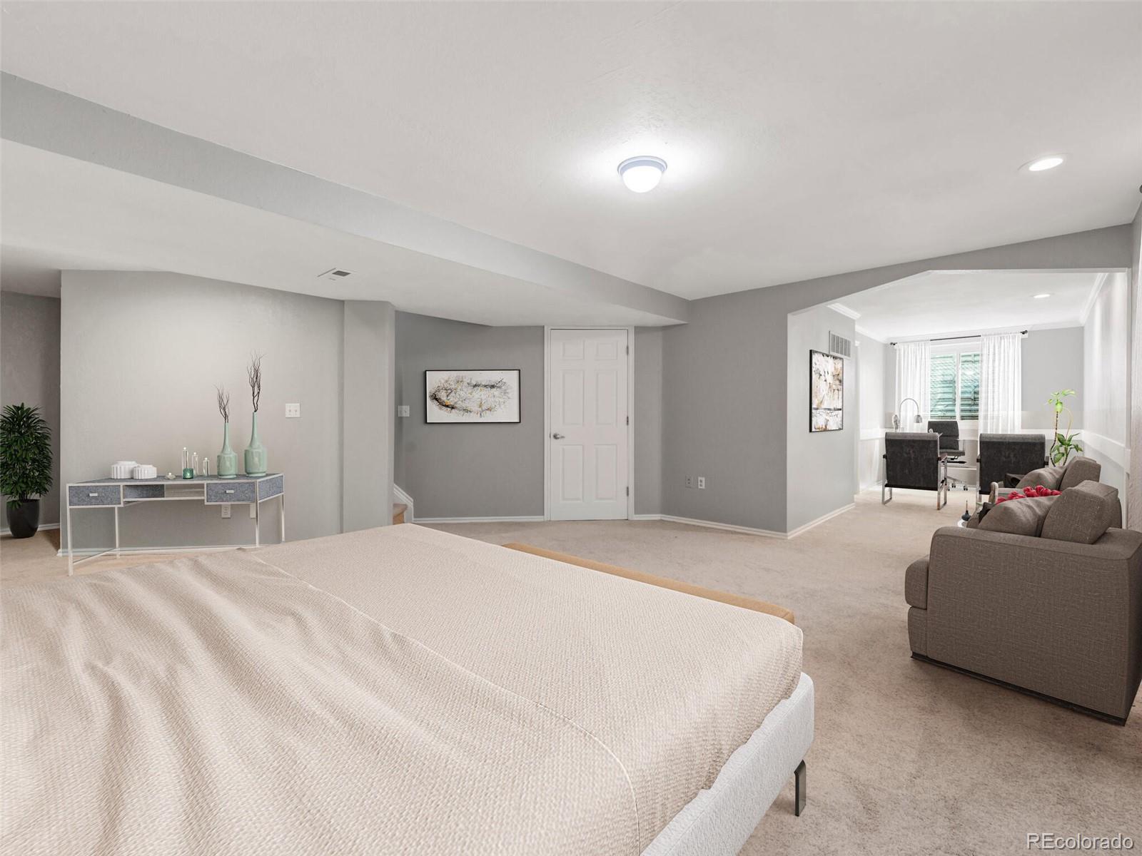 9454 Wolfe Place Highlands Ranch, CO 80129 - Photo 15 of 31 a spacious bedroom with a bed and a large mirror