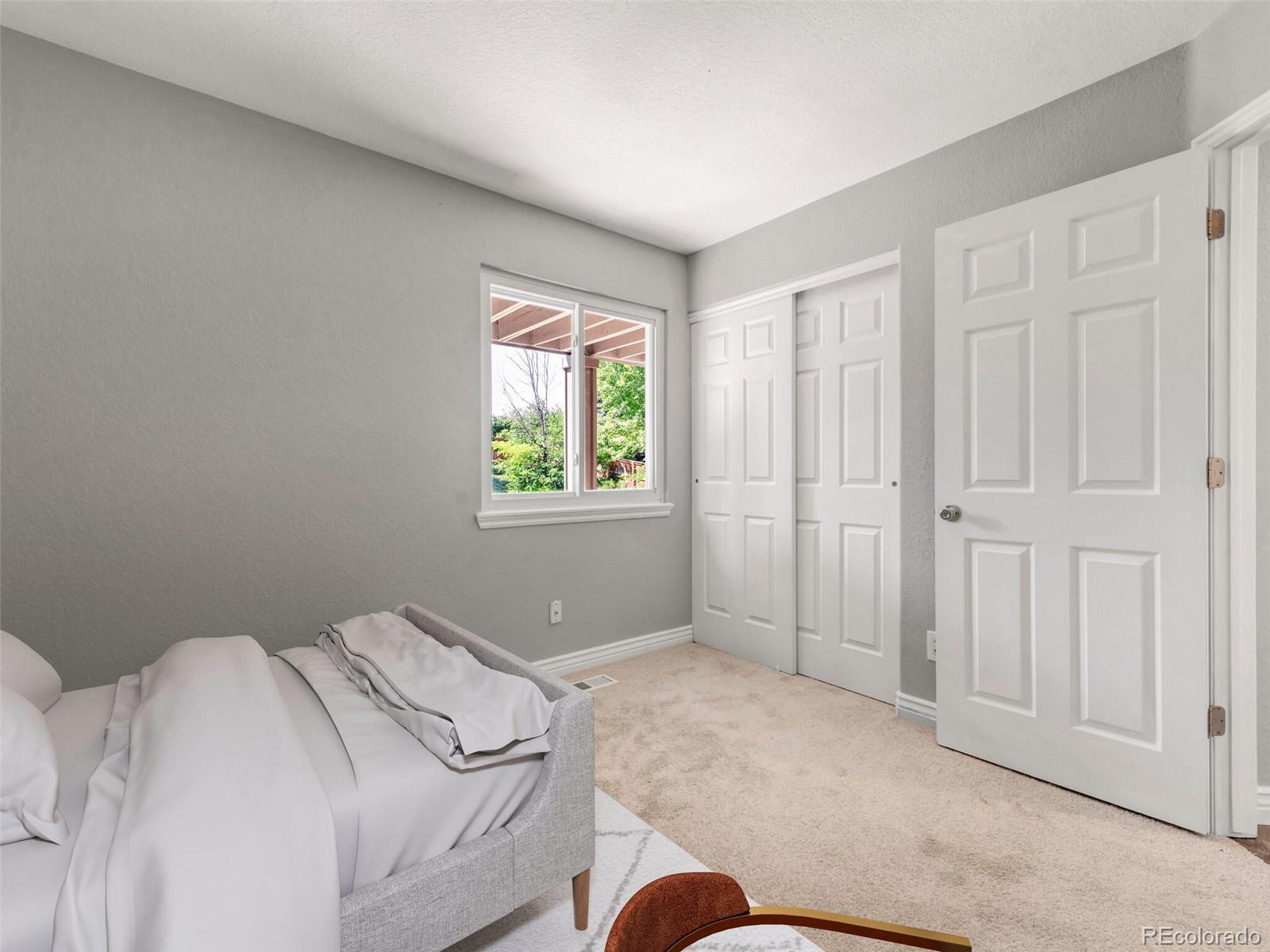 9454 Wolfe Place Highlands Ranch, CO 80129 - Photo 19 of 31 a bedroom with a bed and a window