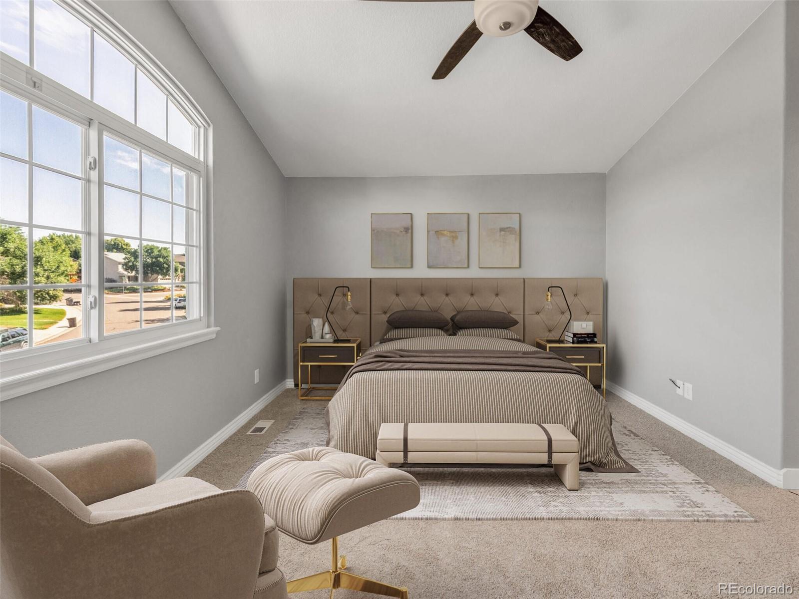 9454 Wolfe Place Highlands Ranch, CO 80129 - Photo 2 of 31 a bedroom with a bed and a couch
