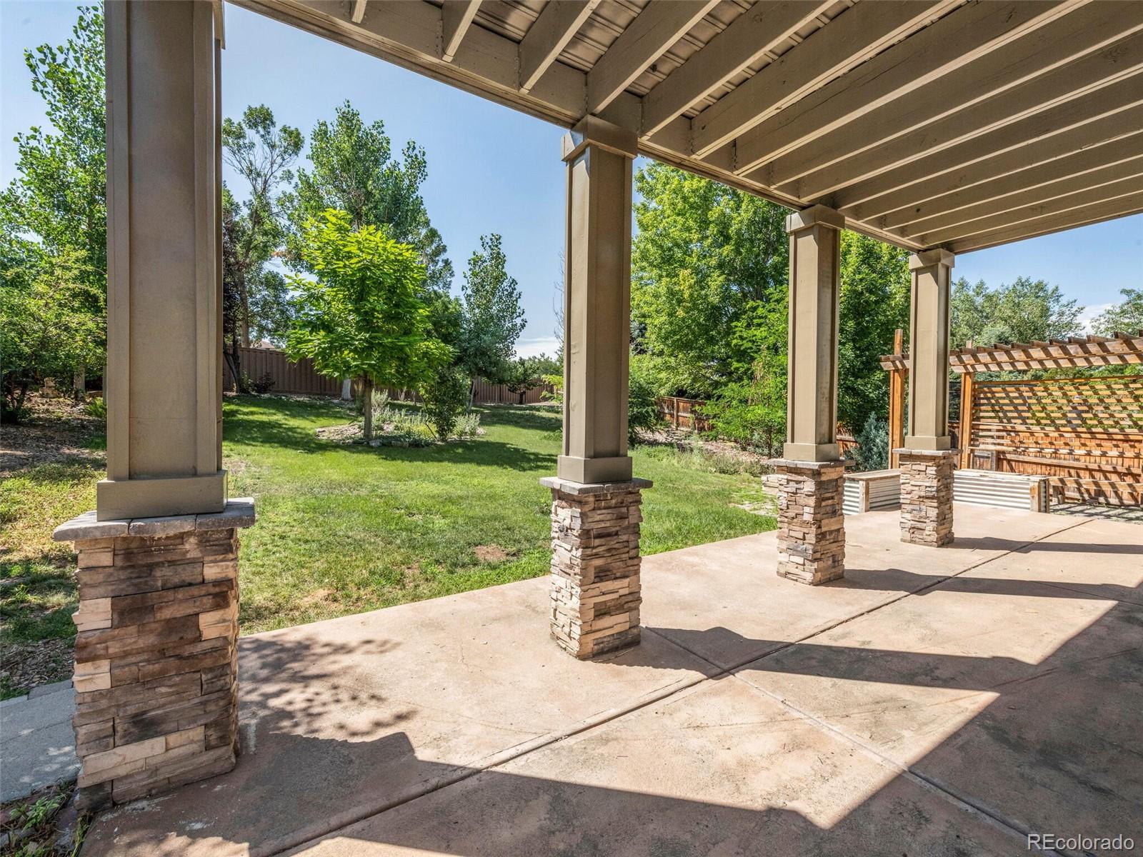9454 Wolfe Place Highlands Ranch, CO 80129 - Photo 26 of 31 a view of a patio with a table chairs and a table