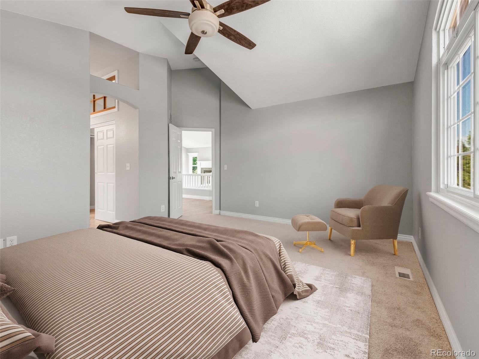 9454 Wolfe Place Highlands Ranch, CO 80129 - Photo 3 of 31 a bedroom with a bed and a chair