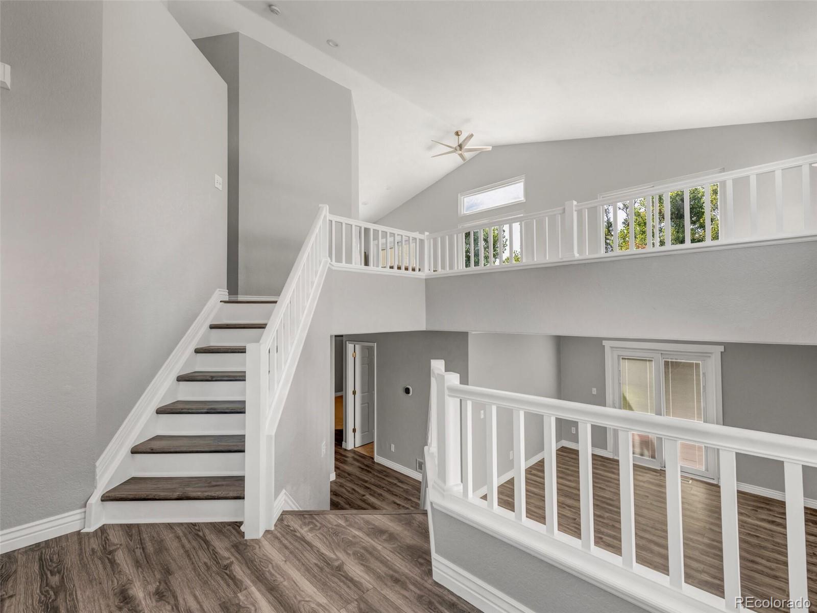9454 Wolfe Place Highlands Ranch, CO 80129 - Photo 10 of 31 a view of staircase with white walls and a window