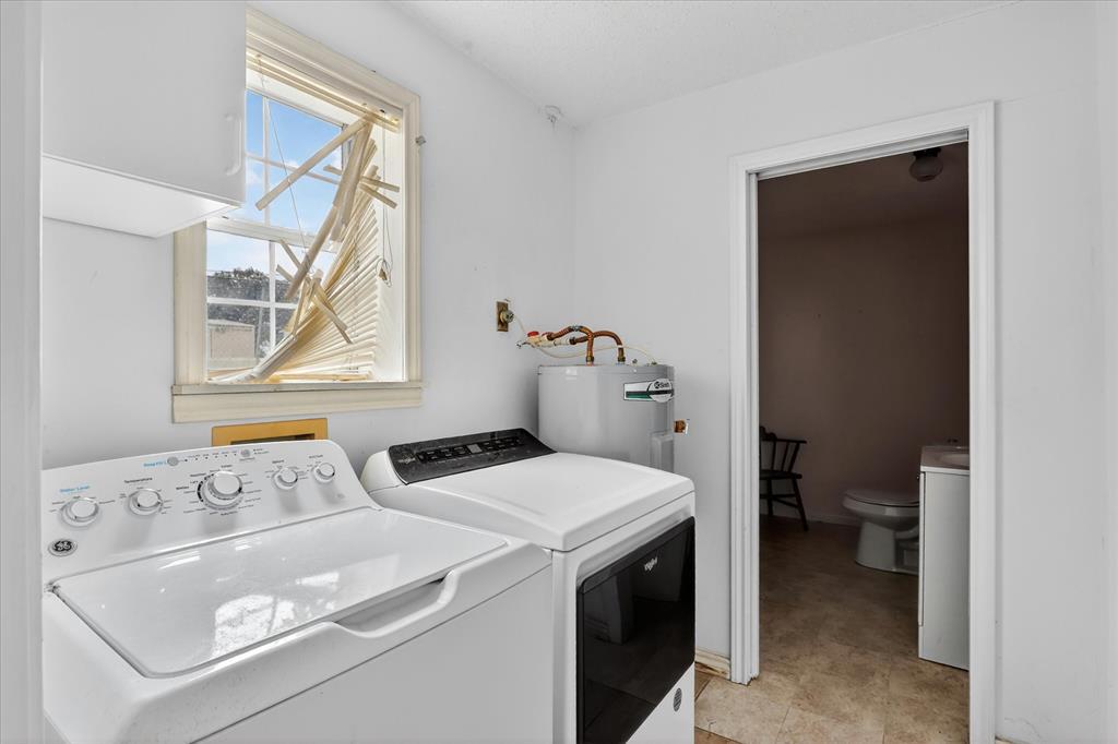1092 West Highway 199 Springtown, TX 76082 - Photo 17 of 29 Laundry area featuring white walls, a window, half bath and a water heater
