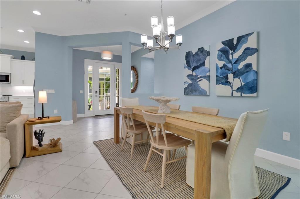 6509 Dominica Drive, Unit 101 Naples, FL 34113 - Photo 7 of 33 a view of a dining room with furniture and wooden floor