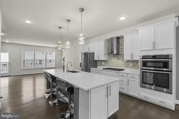 a kitchen with a stove a sink and a refrigerator