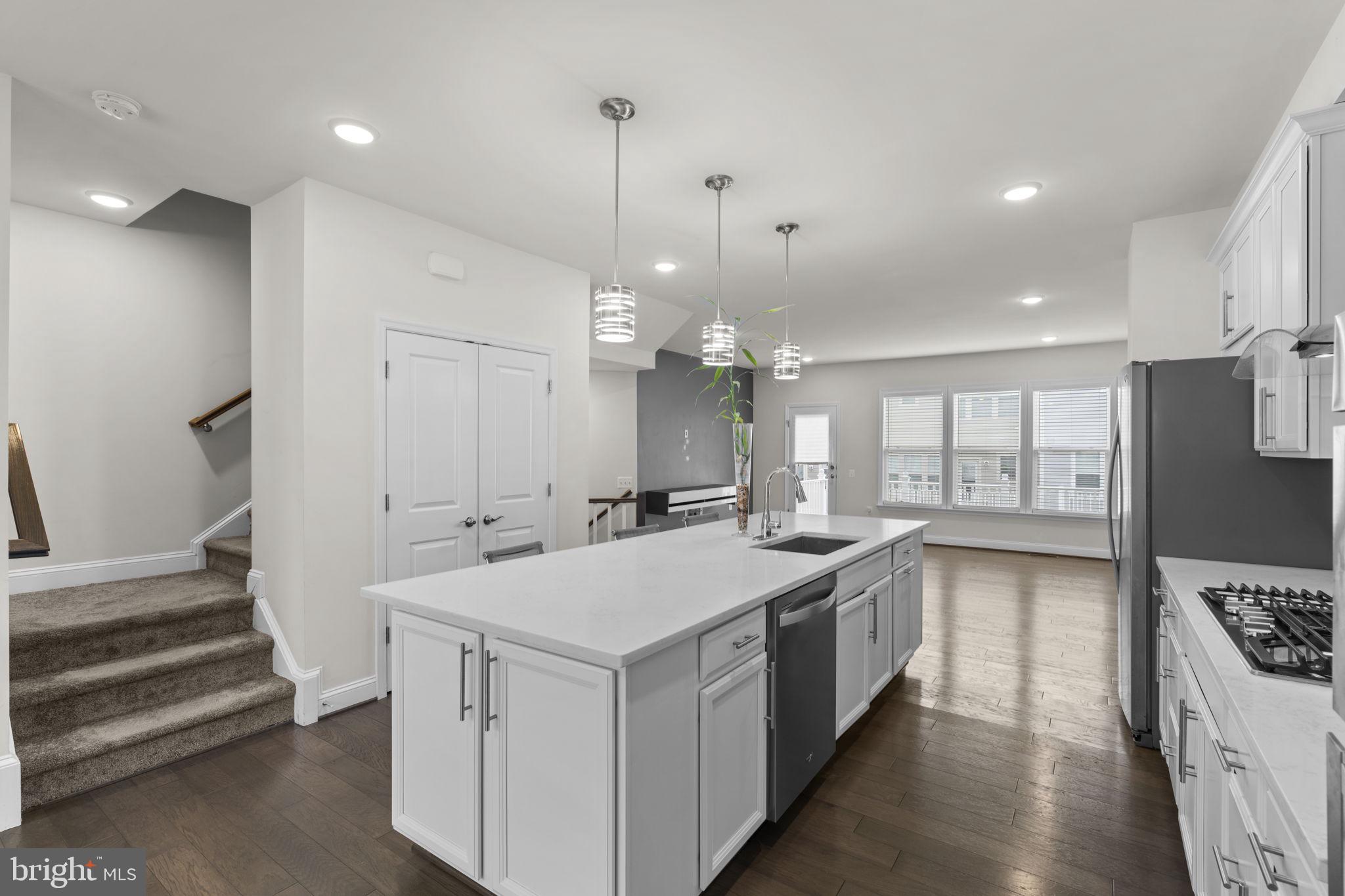 17357 Redshank Road Dumfries, VA 22026 - Photo 13 of 29 a large kitchen with a stove and a sink
