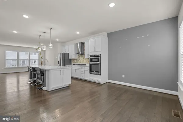a view of kitchen with kitchen island and stainless steel appliances