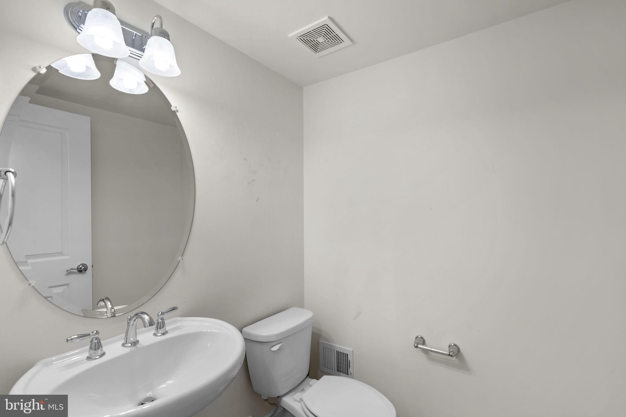 17357 Redshank Road Dumfries, VA 22026 - Photo 17 of 29 a bathroom with a toilet sink and mirror