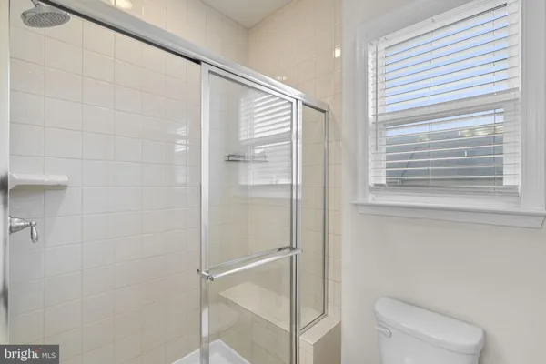 a bathroom with a shower and a toilet