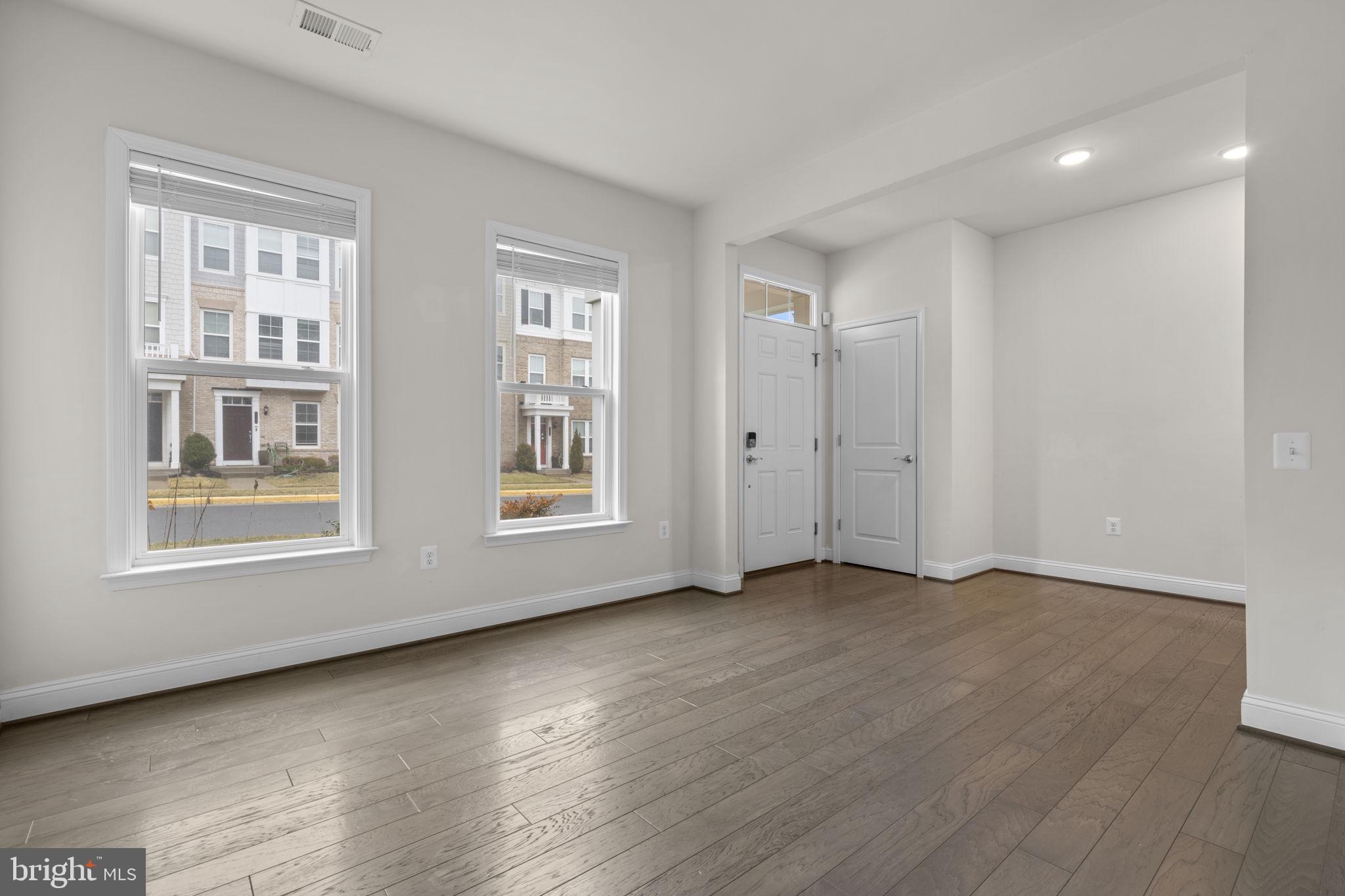 17357 Redshank Road Dumfries, VA 22026 - Photo 3 of 29 an empty room with wooden floor and windows