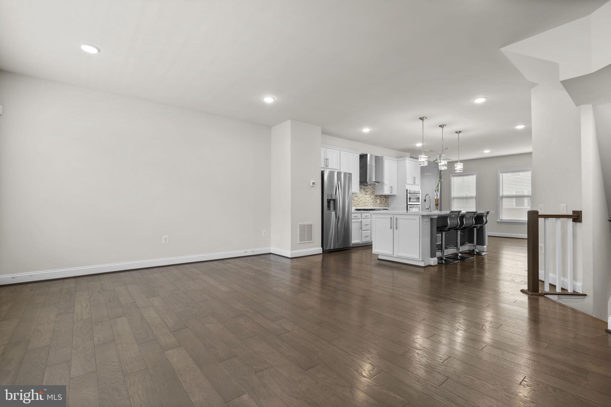 17357 Redshank Road Dumfries, VA 22026 - Photo 7 of 29 a view of kitchen with refrigerator stove and wooden floor