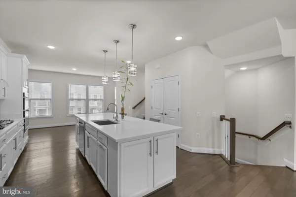 a kitchen with sink stove and refrigerator