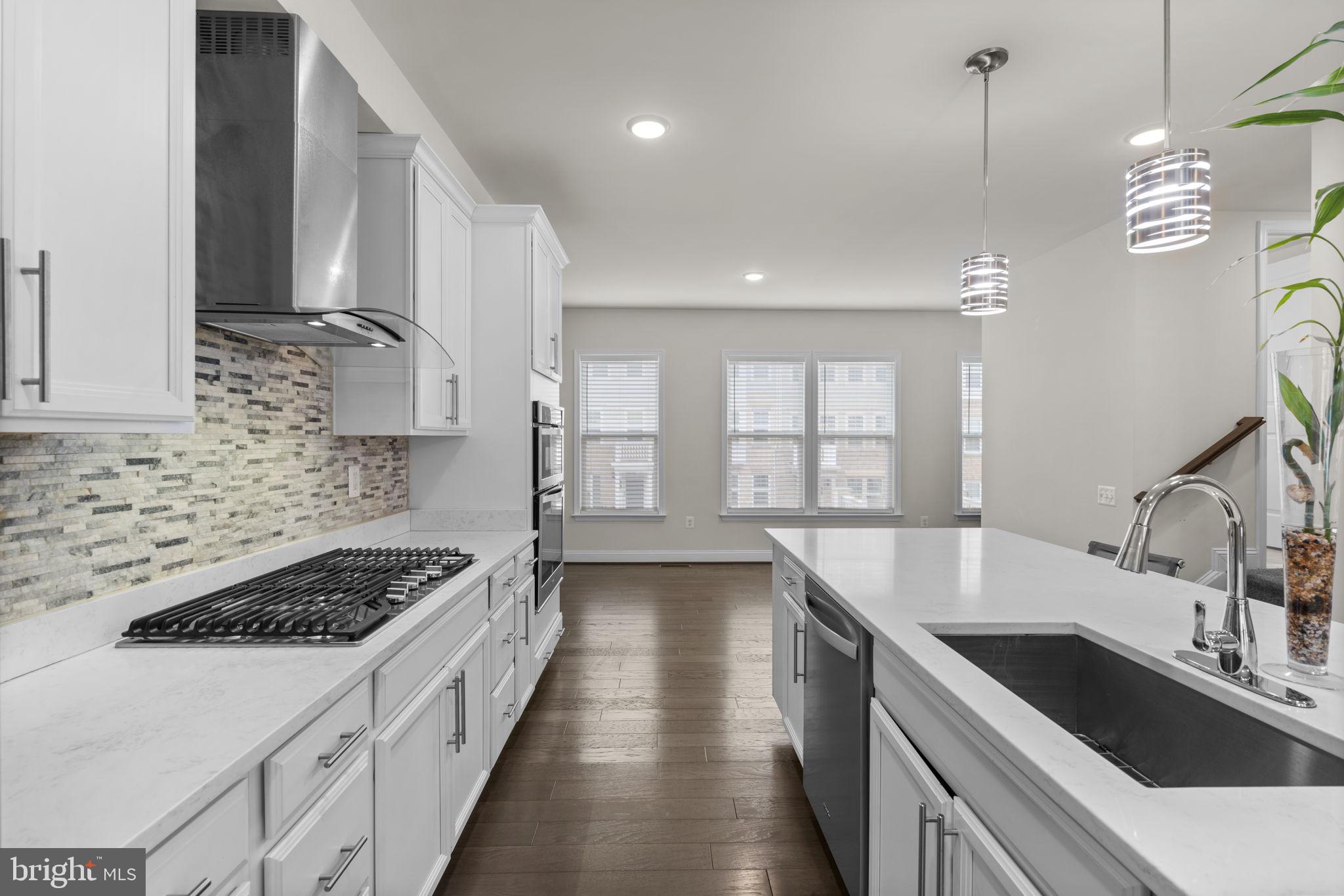 17357 Redshank Road Dumfries, VA 22026 - Photo 10 of 29 a kitchen with granite countertop a sink stove and cabinets